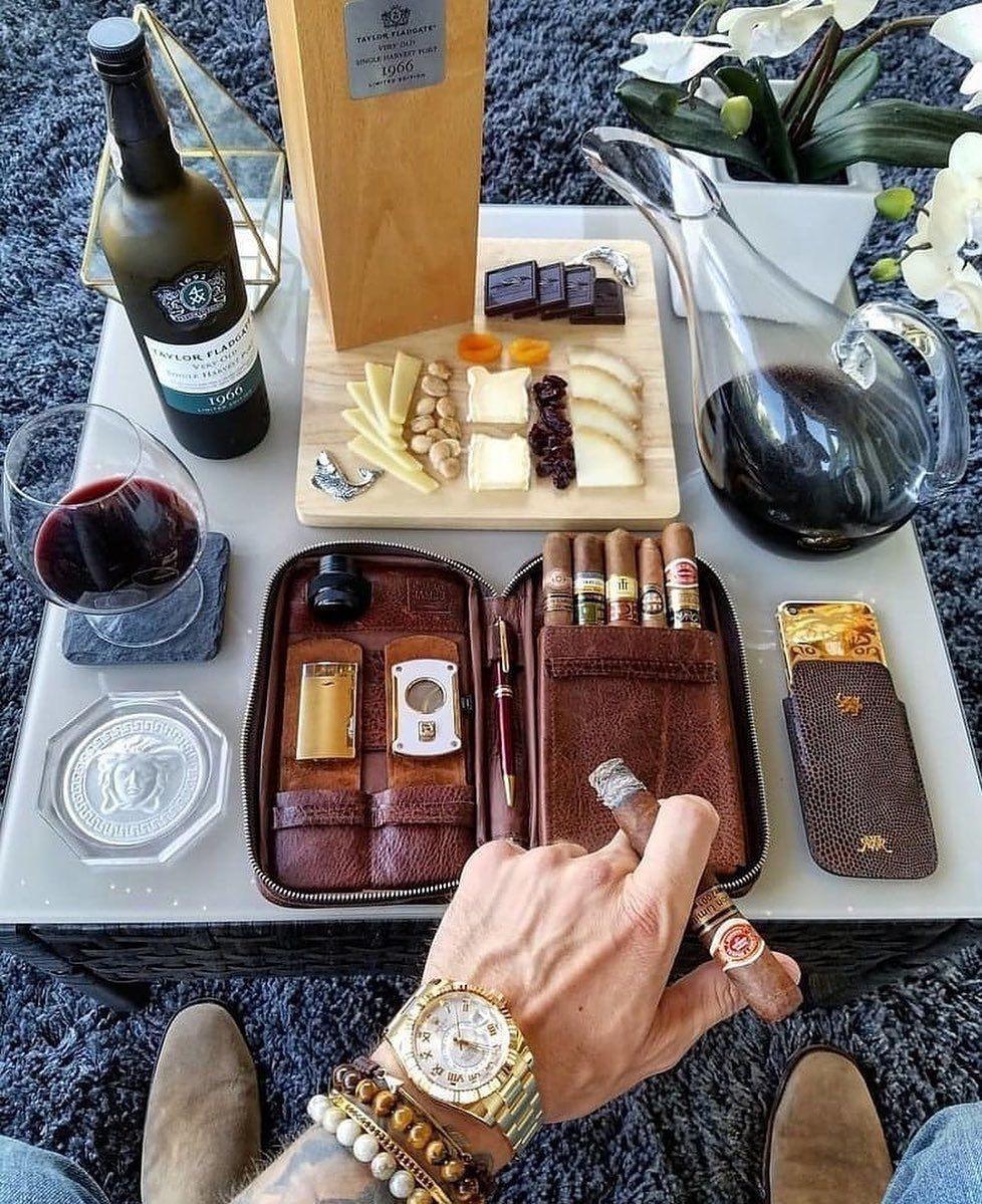 Luxurious life. A successful gentleman in an expensive suit with a cigar and a glass of whiskey or a cup of coffee is eye-catching