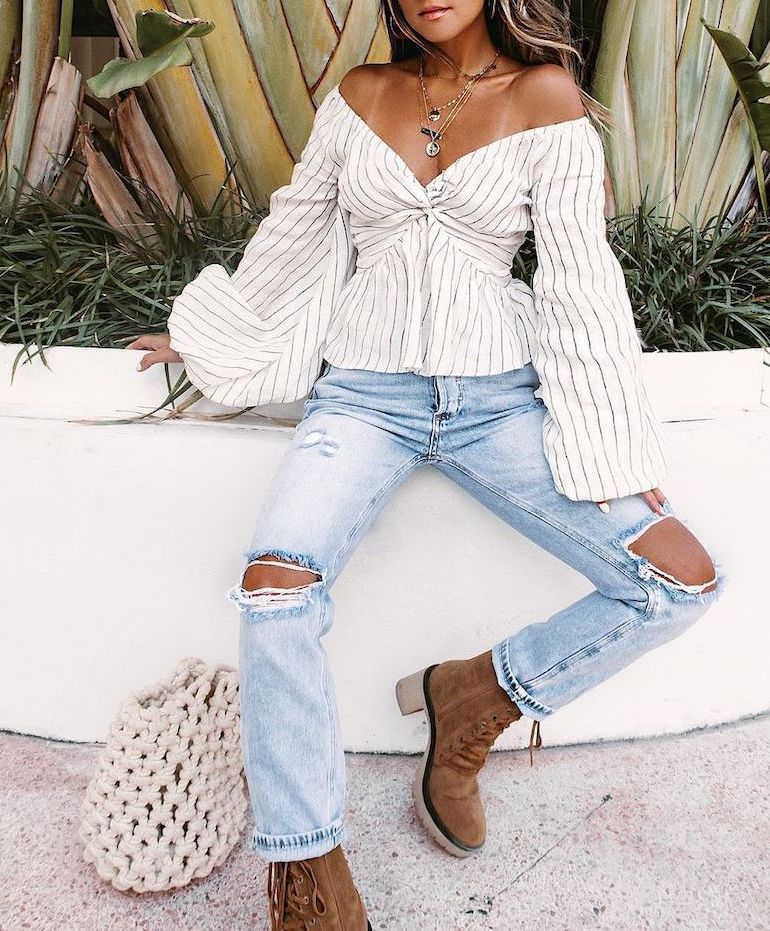 A white wide-cut blouse is a perfect pair for ripped blue jeans 